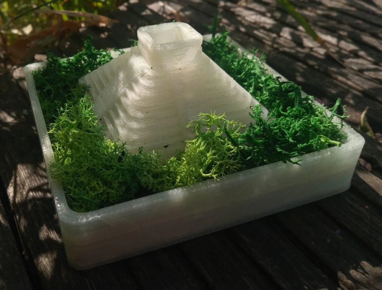 The same planter from a lower angle, highlighting the pyramid shape and top section