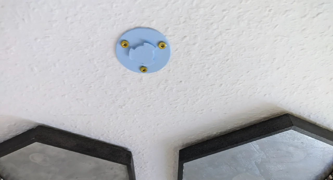 The part with the hooks on the outside screwed into the ceiling using three screws through the provided mounting holes