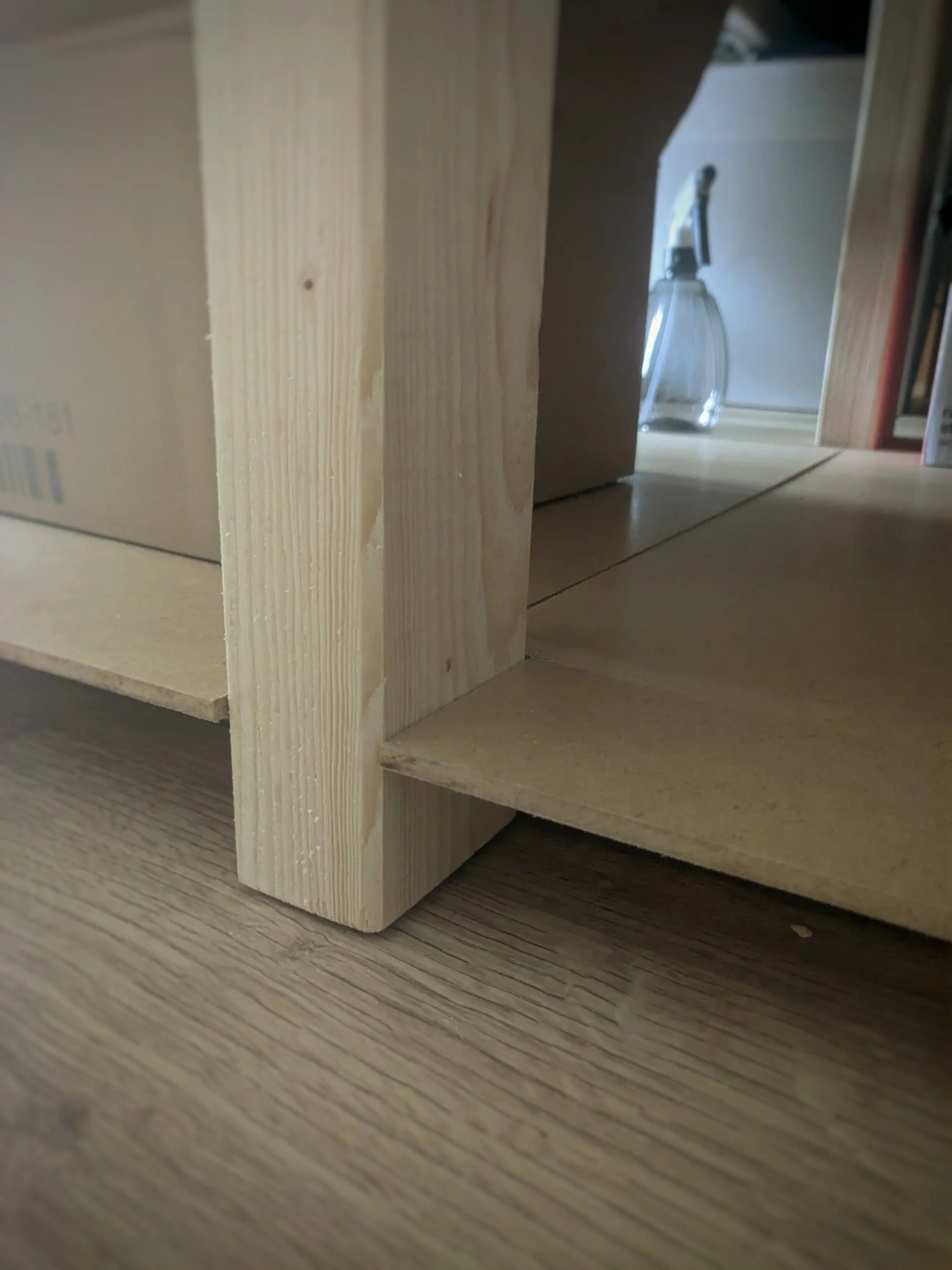 Close up of the 5 mm MDF sitting slightly proud of the floor on top of the shelf support beams.
A small, but visible seam can be made out where one MDF sheet transitions into the next. Close up of the 5 mm MDF sitting slightly proud of the floor on top of the shelf support beams.
A small, but visible seam can be made out where one MDF sheet transitions into the next.