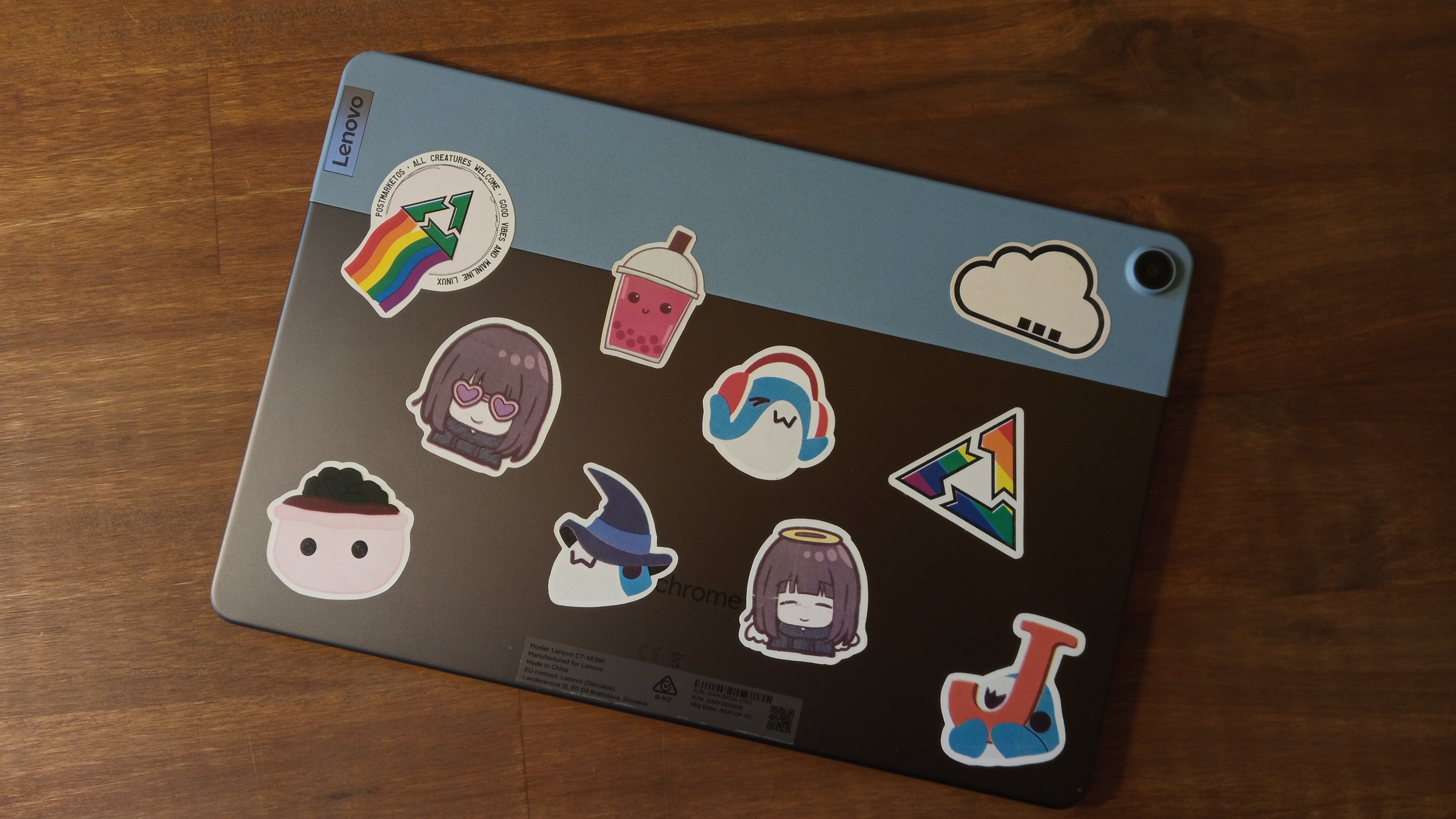 Back of a tablet/Chromebook with a bunch of stickers on it