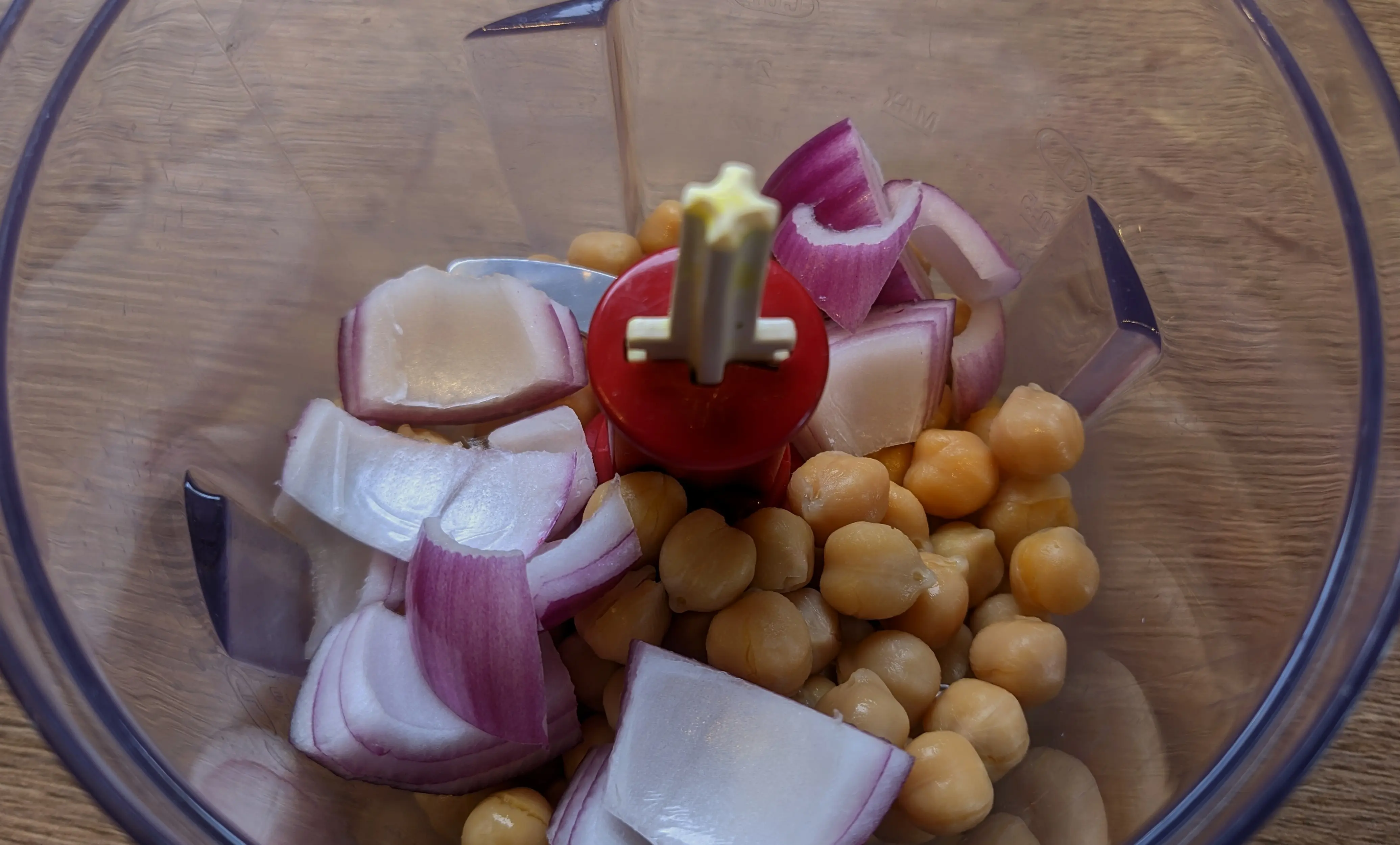 Chickpeas and 2 cm x 2 cm onion pieces in a small food processor