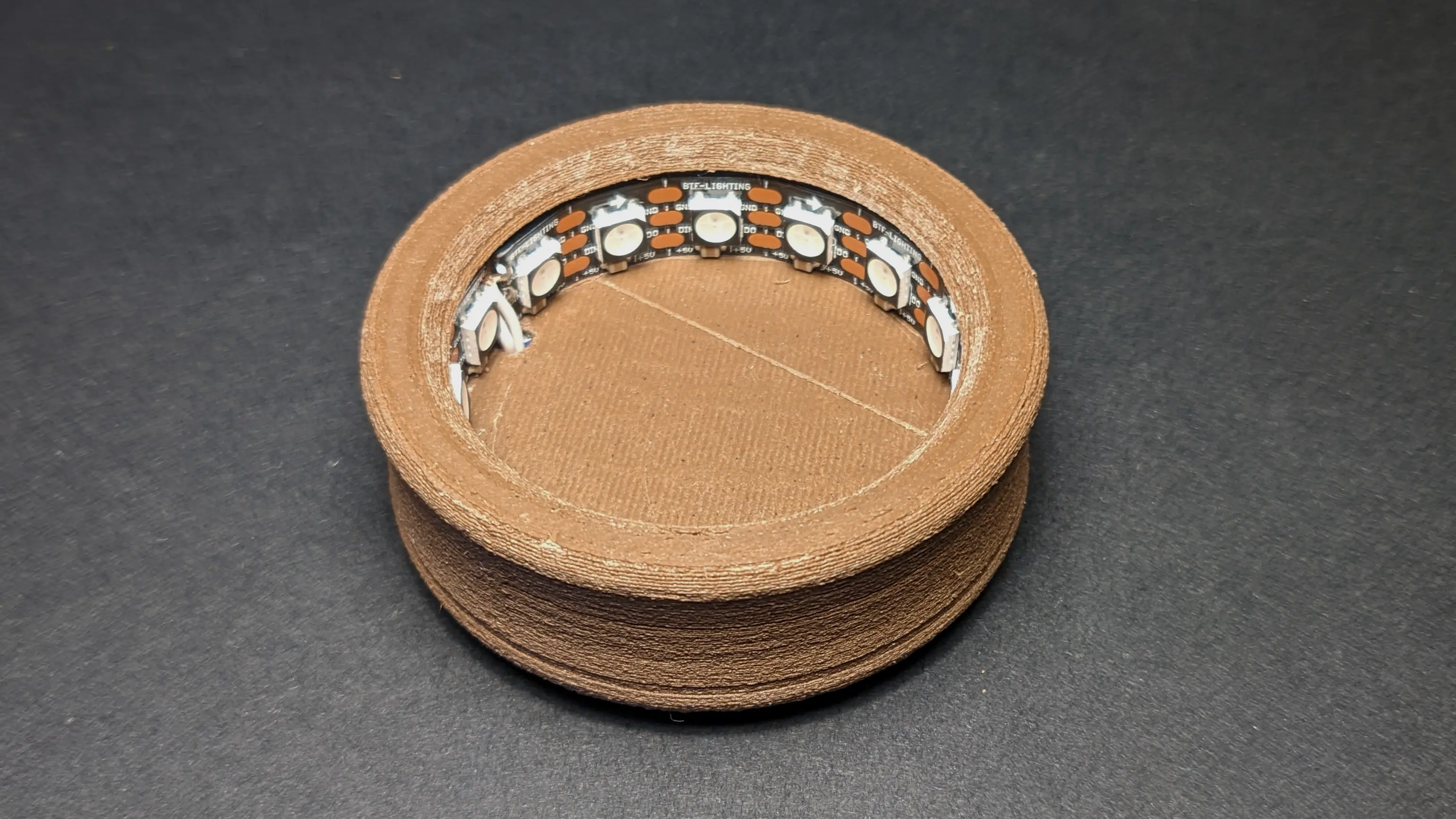 Assembled base without a crystal ball on top.
The camera is pointing at it from an angle, revealing the lead strip, which lines the inside.
You can also make out the curved side section.