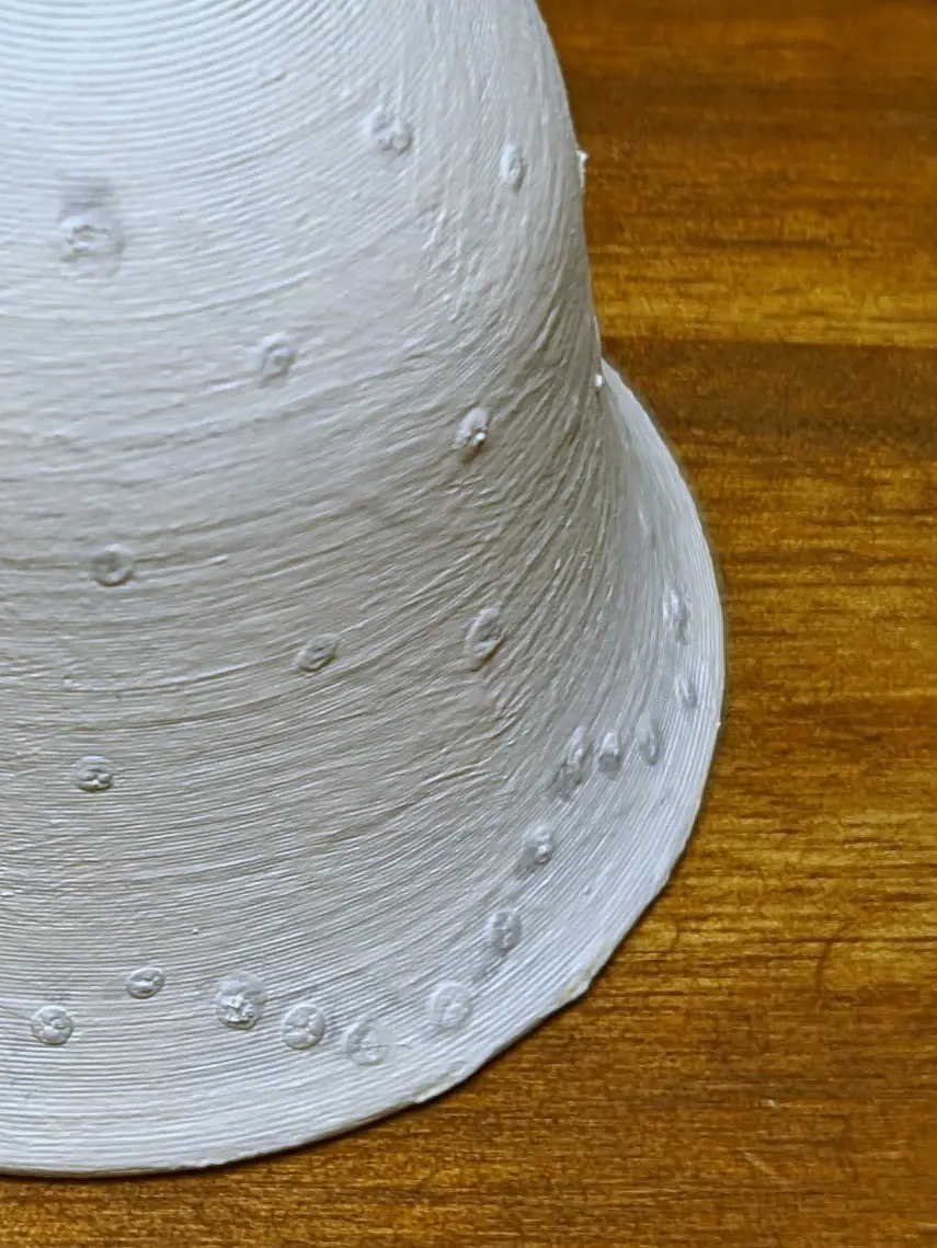 Closeup of the marked areas, which are now slightly raised up, forming bumps along the surface. The glue set in a way that makes them fade in and out with the surface underneath.