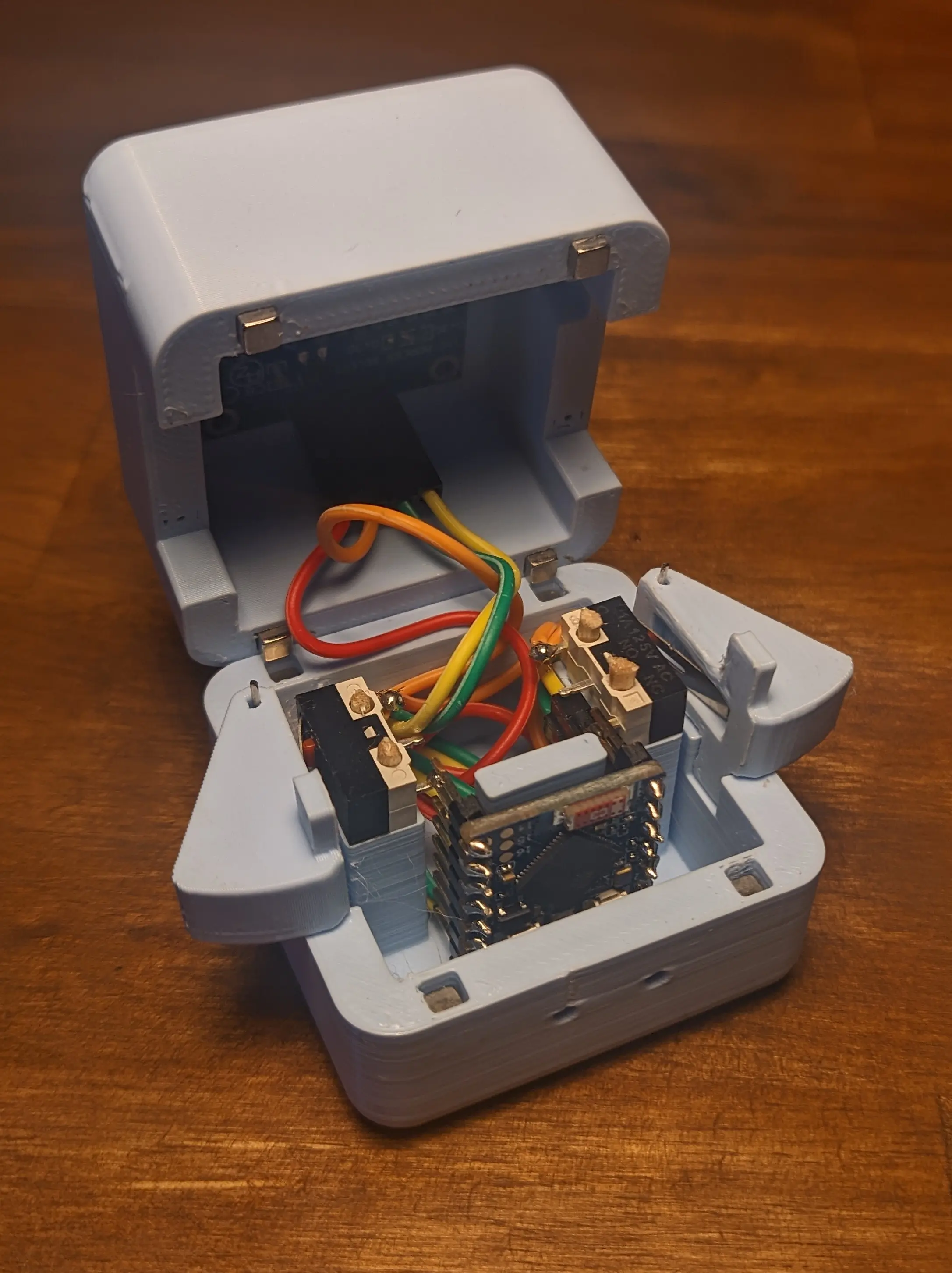 Precious Block opened up along the seam, showing the wires and components on the inside.