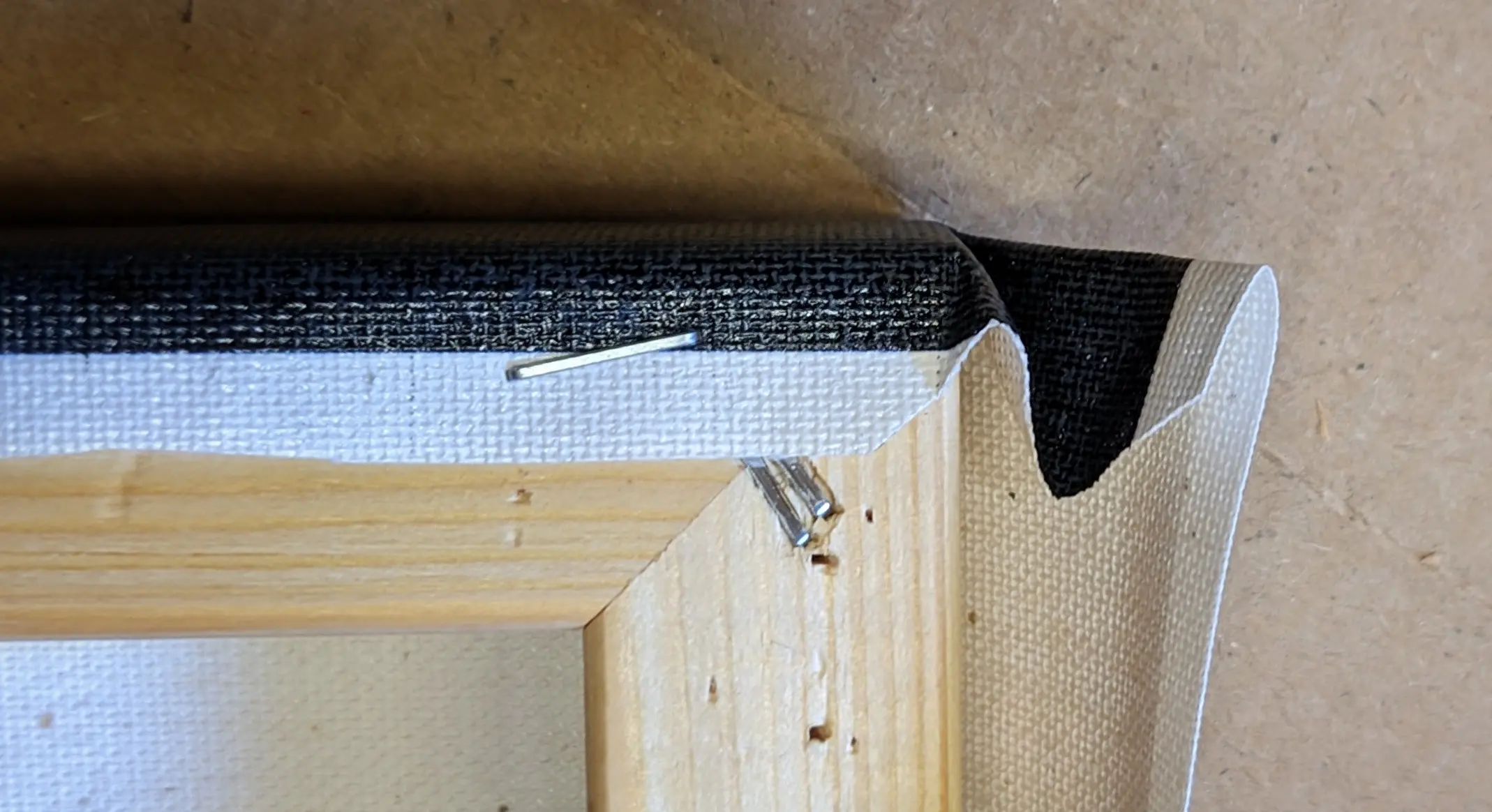 Top-down view of the canvas sheet folded to resemble an M with the leftmost stroke missing.