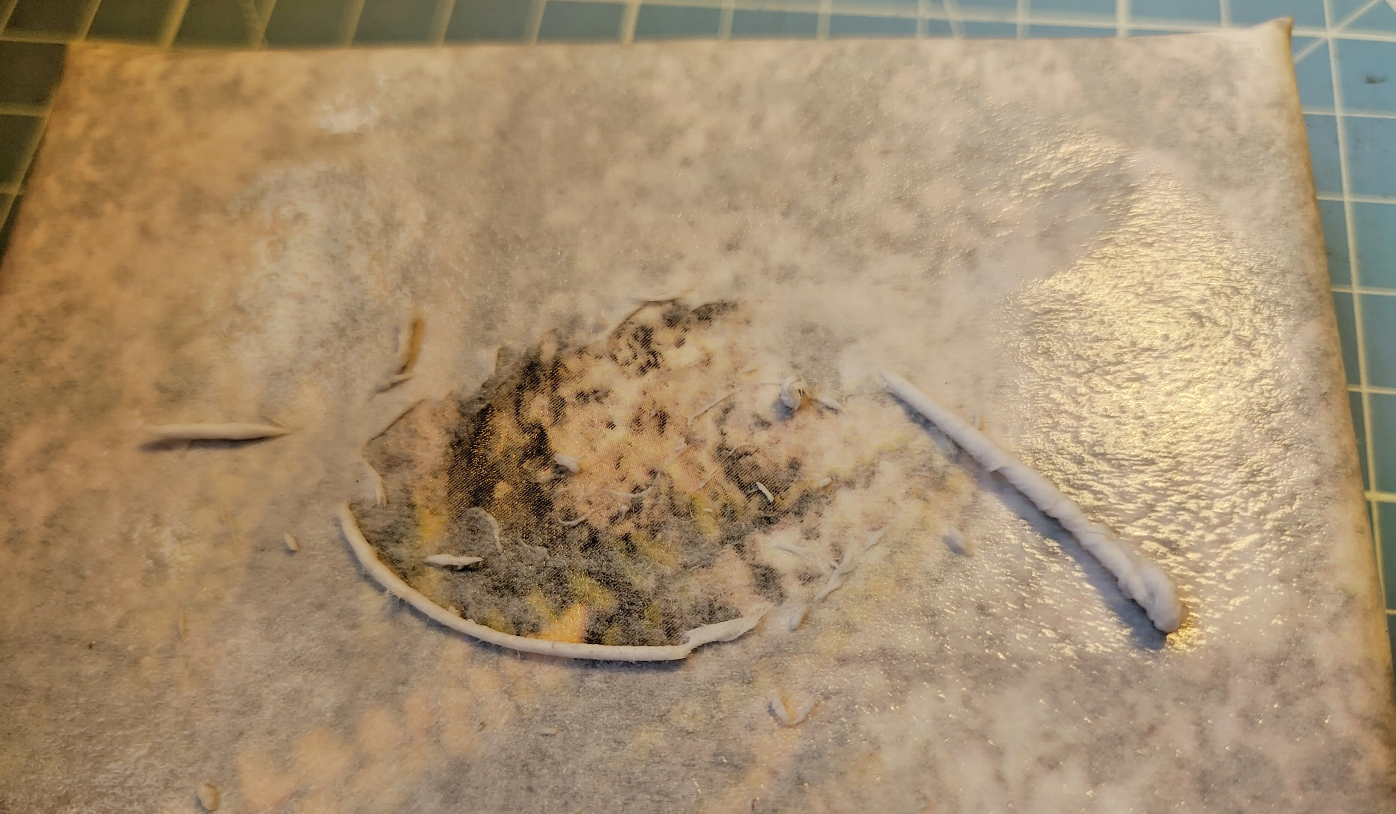 The paper slowly coming of the canvas in rolls