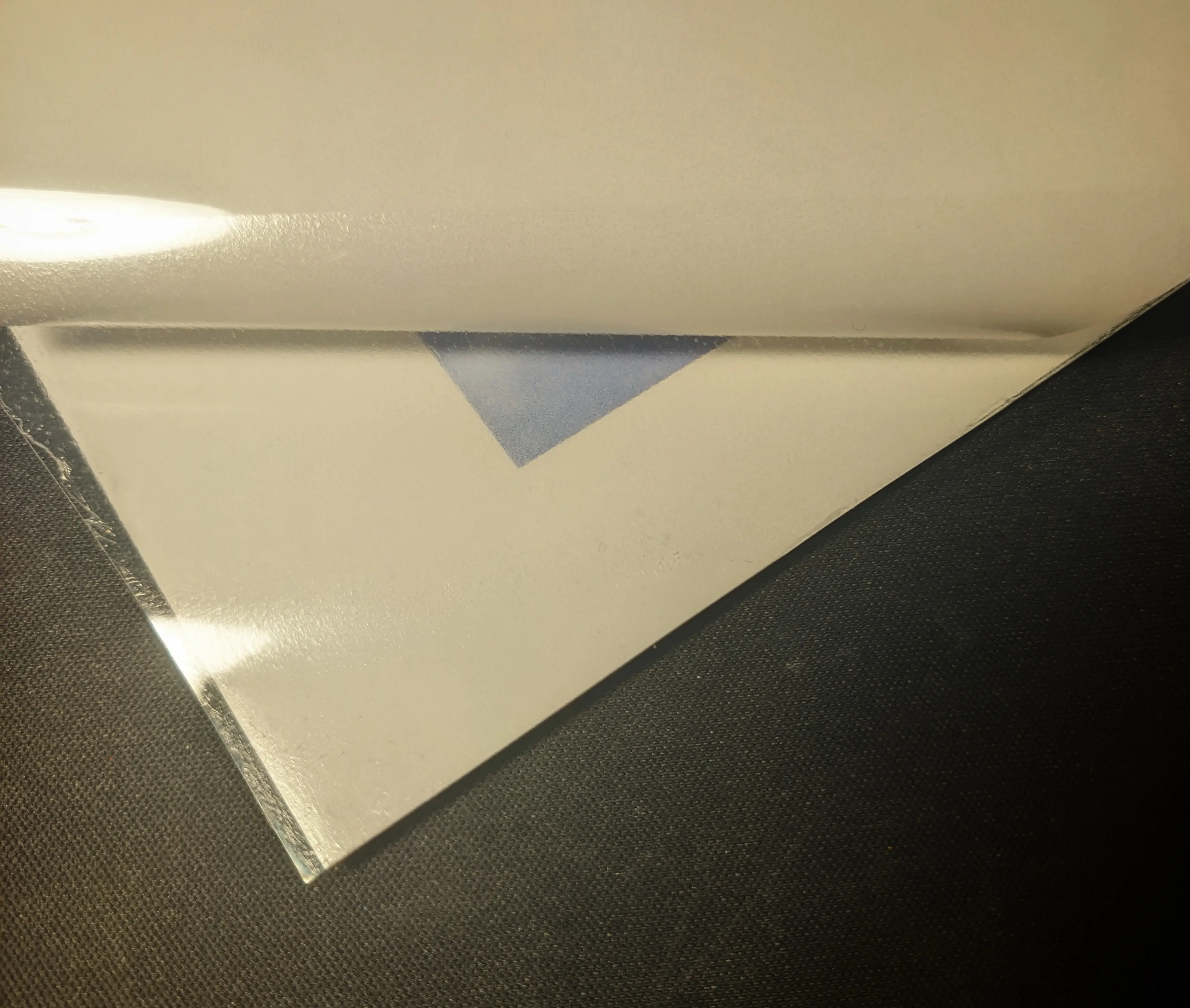 Corner of the printed sheet. The plastic film sits right on the edge of the paper