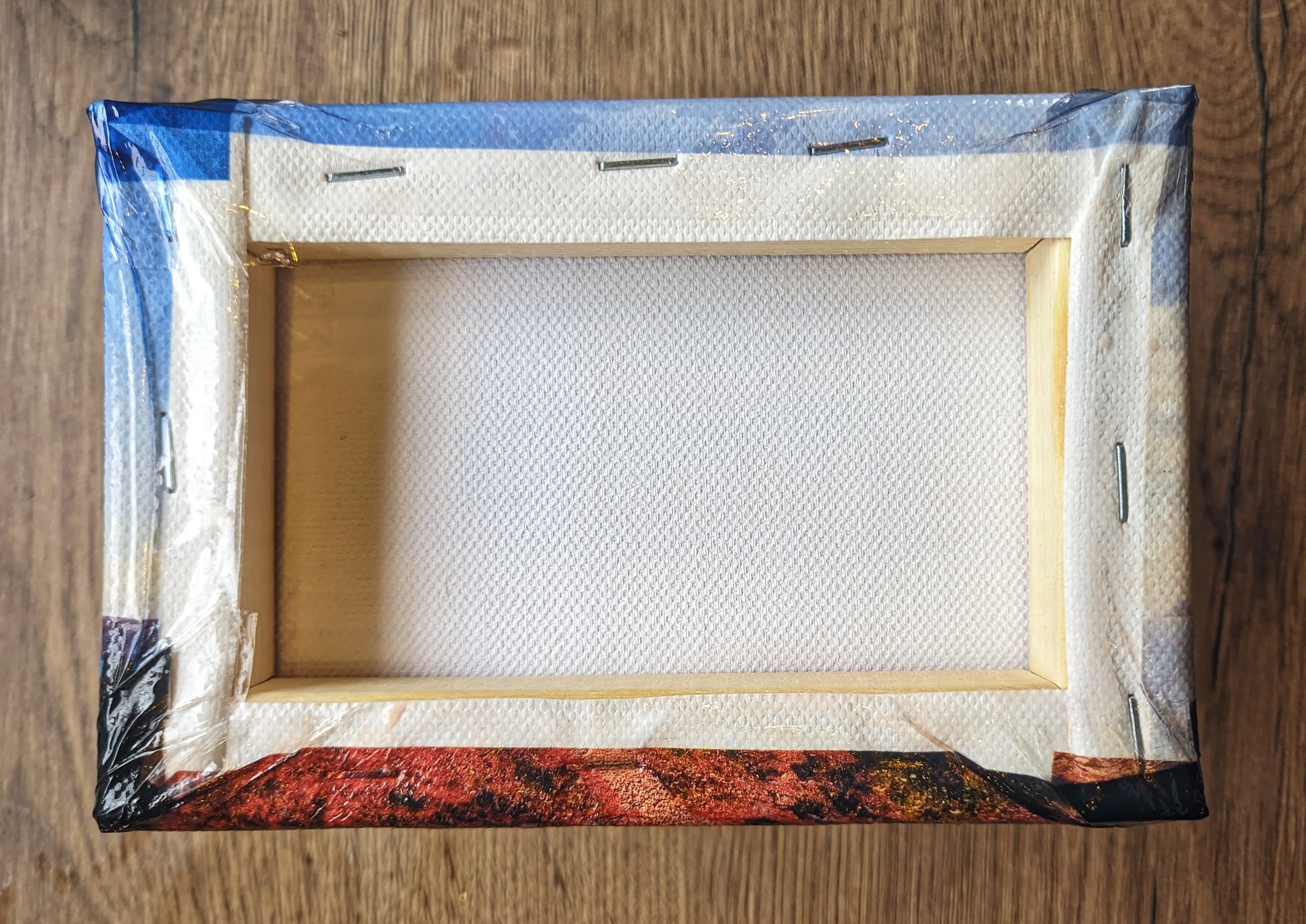 Flipped around canvas, showing the smoothed out plastic film stuck to the back