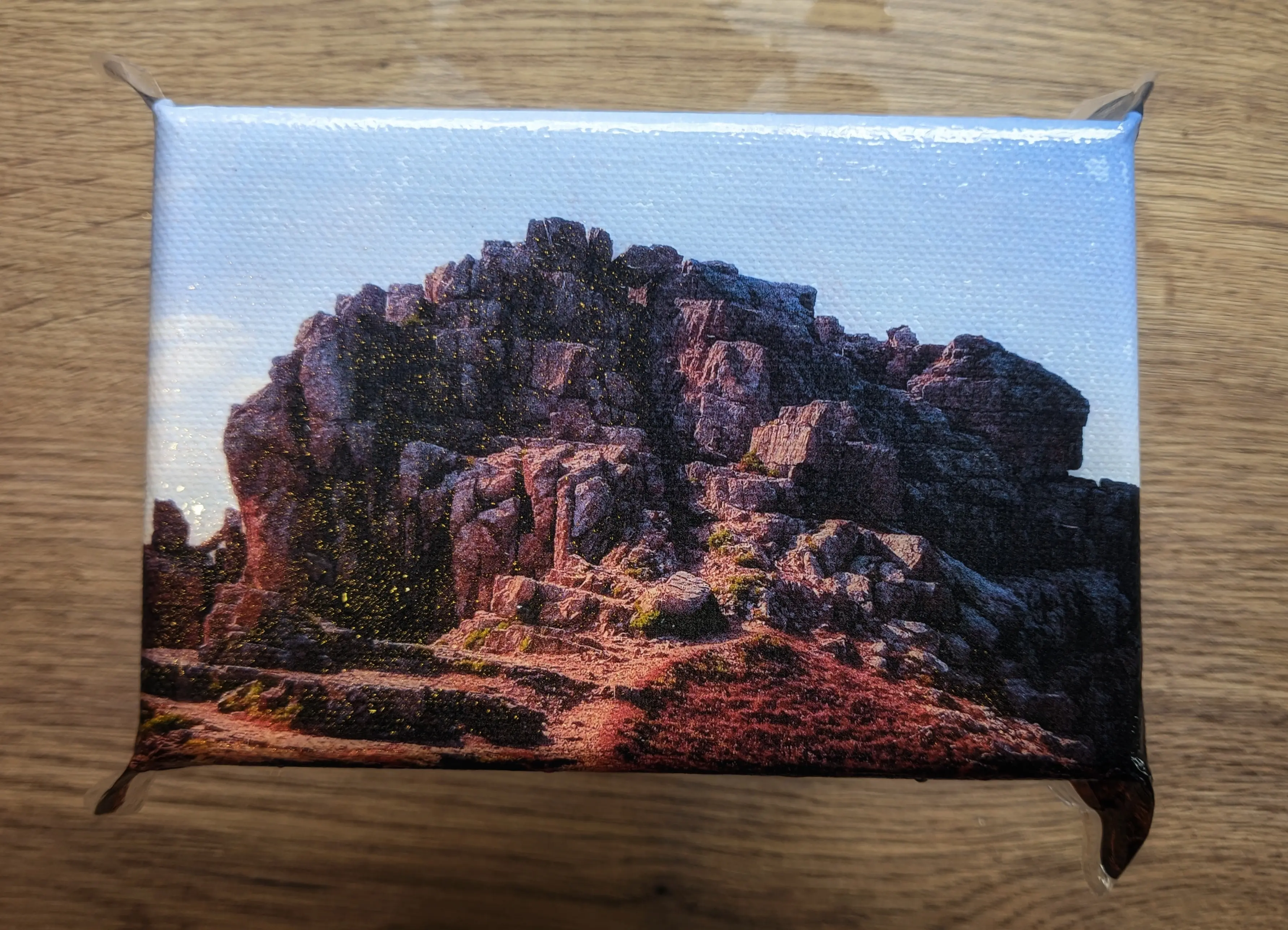 Canvas with the plastic film wrapped around the front and sides from above, showing the plastic flaps formed on the corners.