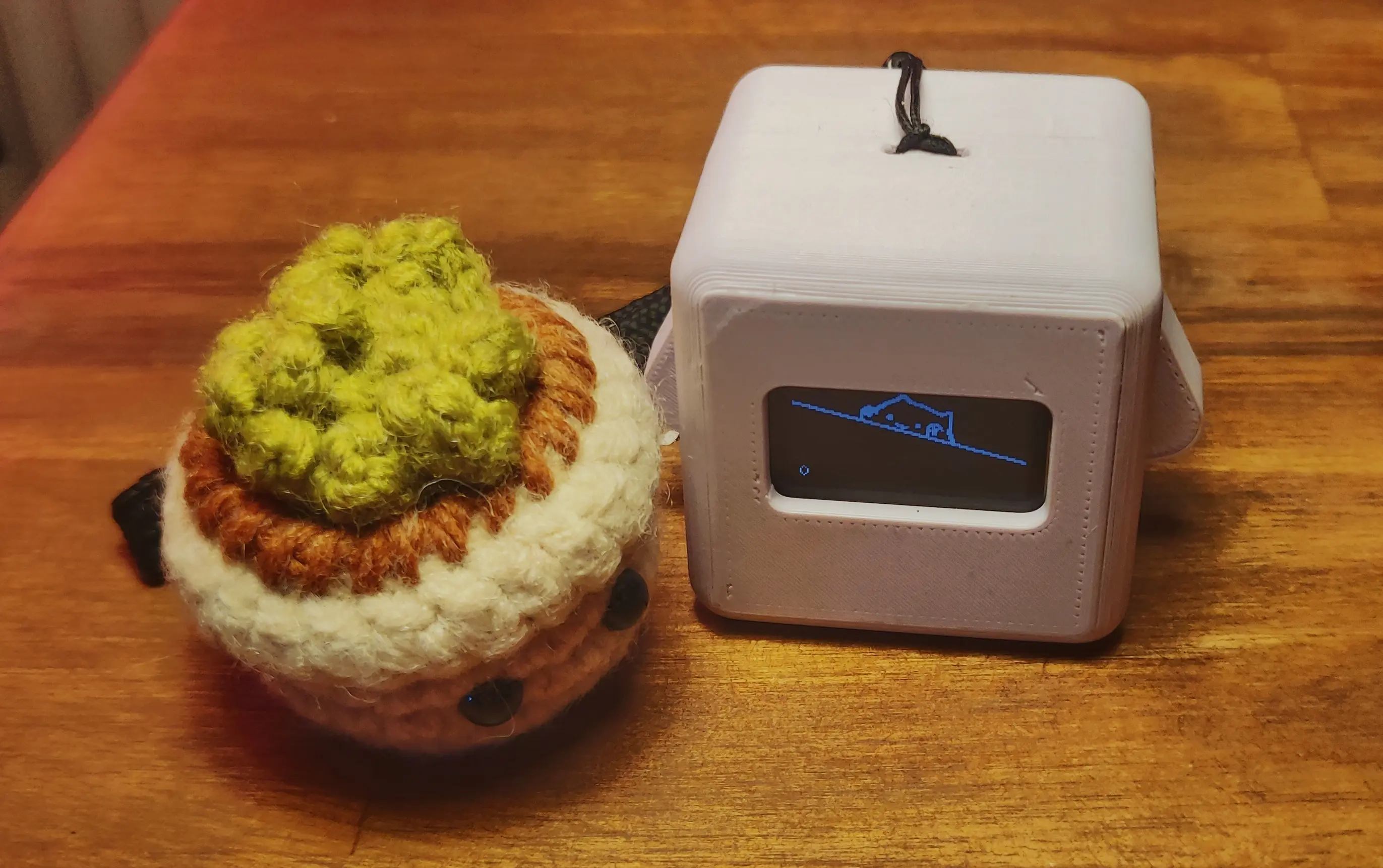 A Precious Block sitting right of the small crochet flowerpot.
The display shows the typical BongoCat with both arms pointing up and a 0 counter in the bottom left.