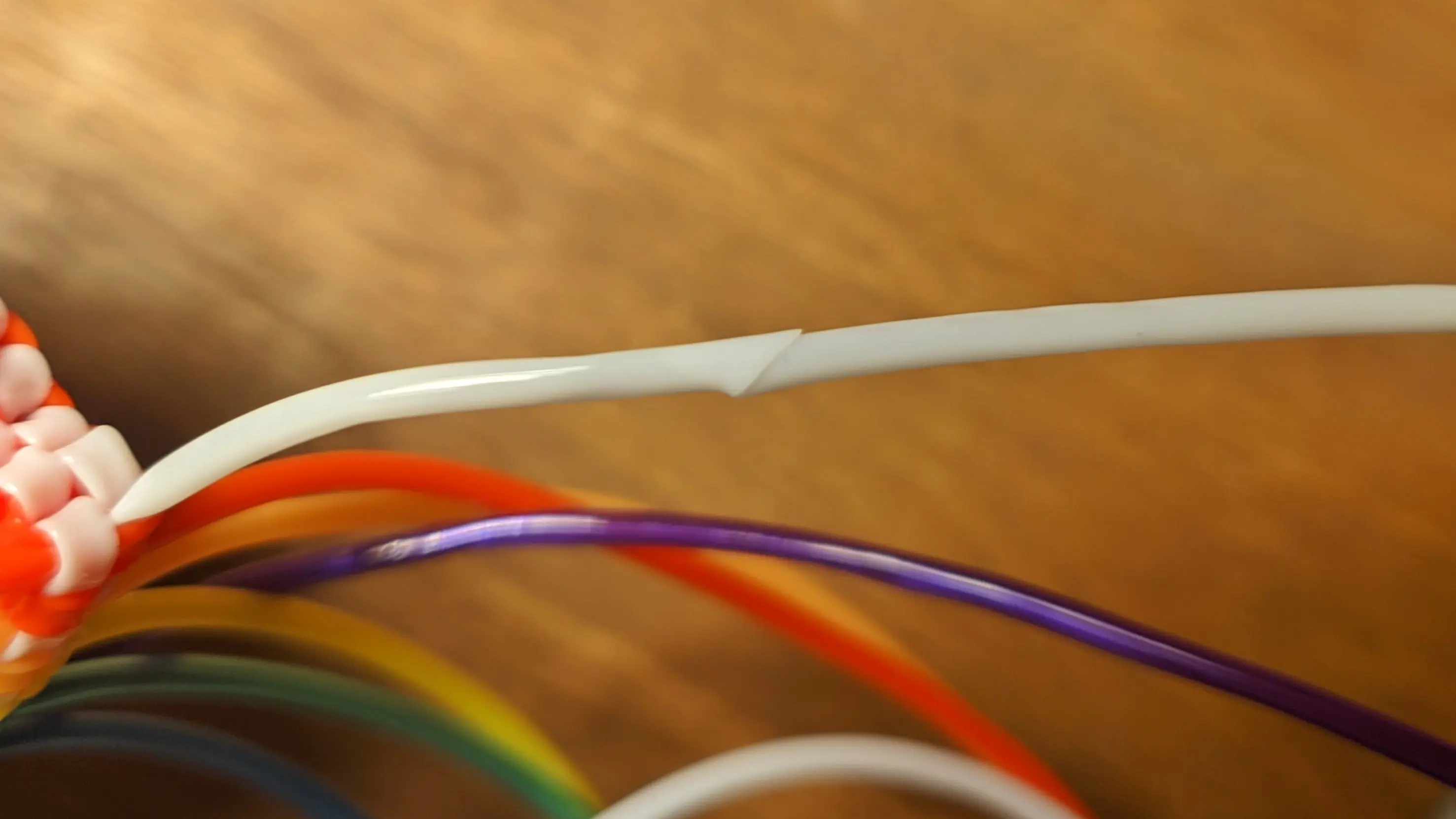 Closeup of the two white strands pushed into each other and melted together.