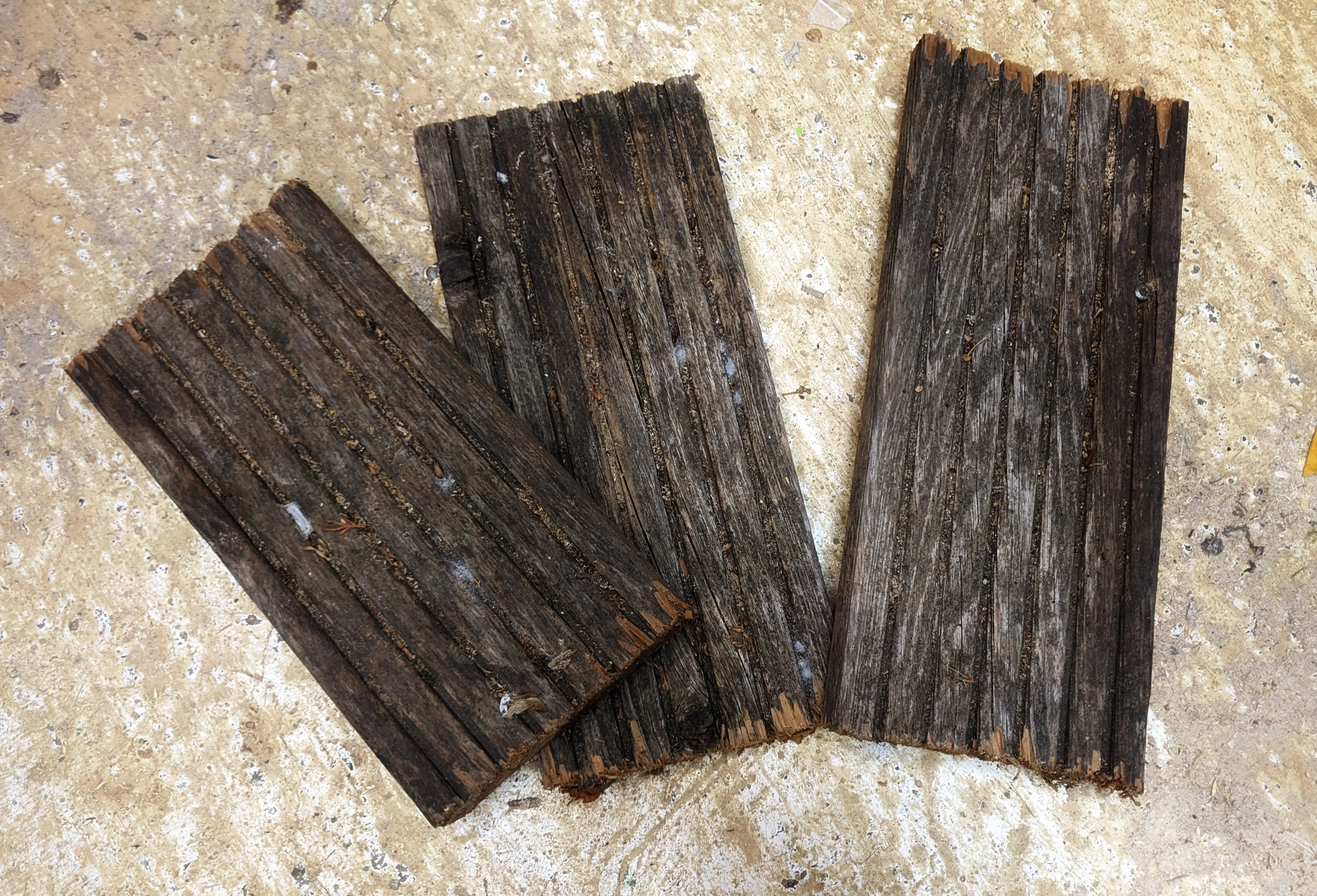 Three scrap pieces of wooden planks lying on the floor