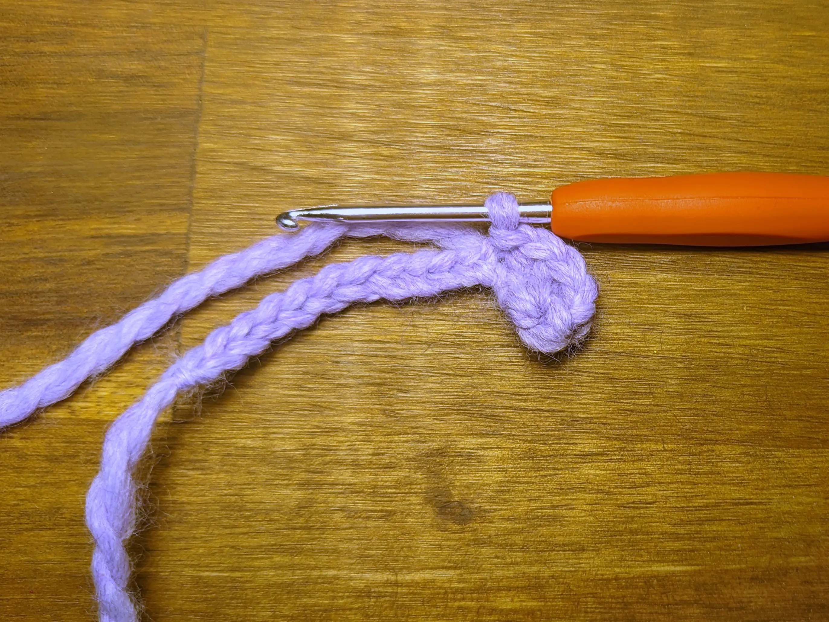Oval-shaped petal formed on the lavender crochet chain.