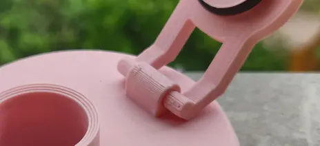 Close-up of the lid mounting mechanism, where twe two tiny arms connect to the main cap body.